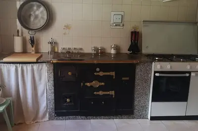 a kitchen with a stove and a counter top at Casa O Coto in Grañas