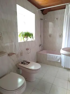 a bathroom with a toilet and a sink and a tub at Casa O Coto in Grañas