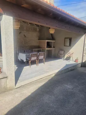 a patio with chairs and a table and a counter at Casa do Porto in Partovia