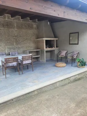 a patio with a table and chairs and an oven at Casa do Porto in Partovia
