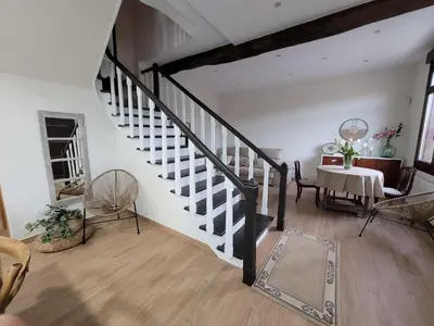 a living room with a staircase and a table and chairs at Casa do Porto in Partovia