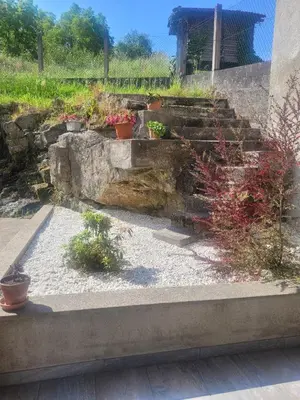 a garden with potted plants on a stone staircase at Casa do Porto in Partovia