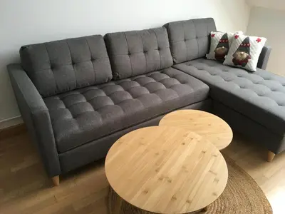 a living room with a gray couch and two tables at Alquiler de piso nuevo in Burela de Cabo
