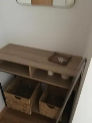 a wooden shelf in a room with baskets at Alquiler de piso nuevo in Burela de Cabo