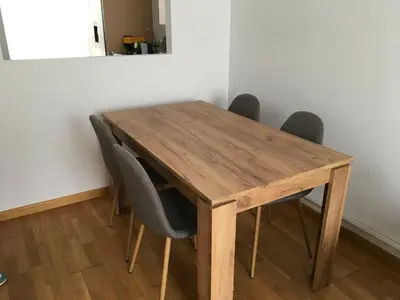 a wooden table with chairs around it in a room at Alquiler de piso nuevo in Burela de Cabo