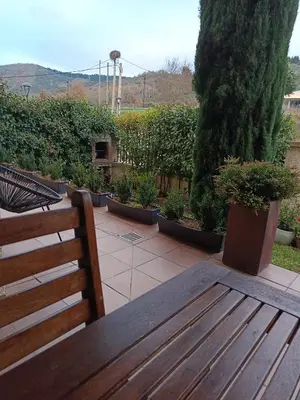 a wooden bench sitting on top of a patio at BenedettaMolinaseca VuT in Molinaseca