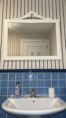 a bathroom with a sink and a mirror at BenedettaMolinaseca VuT in Molinaseca