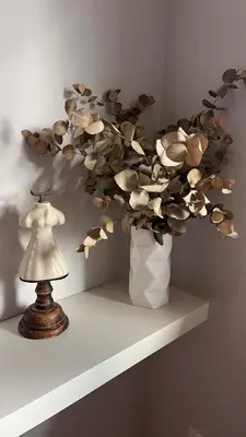 a vase filled with flowers on a shelf next to a lamp at BenedettaMolinaseca VuT in Molinaseca
