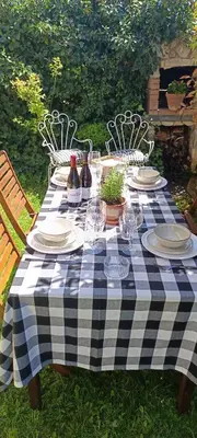 a picnic table with plates and wine bottles on it at BenedettaMolinaseca VuT in Molinaseca