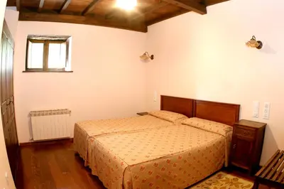 a bedroom with a bed and a window at Hotel Monumento Pazo do Castro in O Barco de Valdeorras