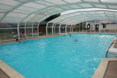 a large swimming pool with a clear roof at Hotel Monumento Pazo do Castro in O Barco de Valdeorras