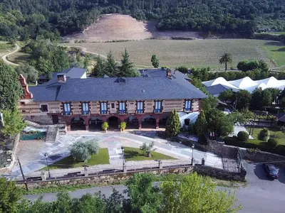 an aerial view of a large house with a river at Hotel Monumento Pazo do Castro in O Barco de Valdeorras