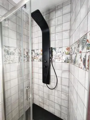 a shower with a black shower head in a bathroom at Gallaecia in Arzúa
