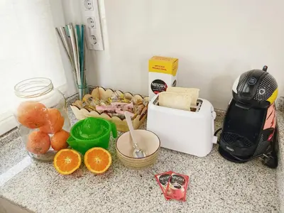a counter top with a bunch of food and a toaster at Gallaecia in Arzúa
