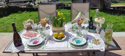 a table with food and flowers and wine bottles at El cobijo de Soar ¡Casa rural completa! in Moraña