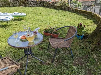 a table with a plate of food and drinks on it at El cobijo de Soar ¡Casa rural completa! in Moraña