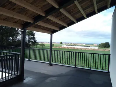 a screened porch with a view of the pasture at Anam Cara House in Serantes
