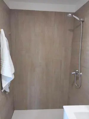 a bathroom with a shower with a toilet and a sink at Anam Cara House in Serantes