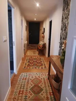 a hallway with a rug on the floor and a hallway with a hallway at O Noso Lar - RIBEIRA SACRA in Nogueira de Ramuin