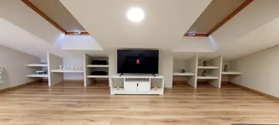 a living room with a flat screen tv on a white cabinet at Casa Tarrazo II in Monforte de Lemos