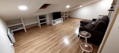 a living room with a couch and a tv at Casa Tarrazo II in Monforte de Lemos