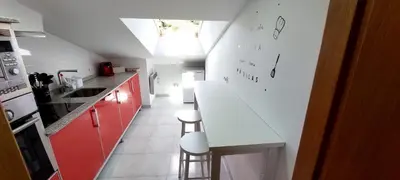 a kitchen with red cabinets and a white counter top at Casa Tarrazo II in Monforte de Lemos