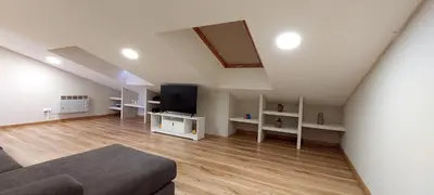 a living room with a couch and a flat screen tv at Casa Tarrazo II in Monforte de Lemos