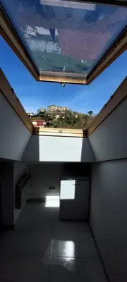 an attic room with a window with a view at Casa Tarrazo II in Monforte de Lemos