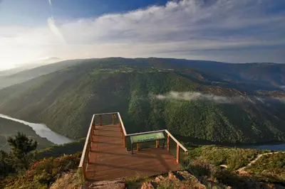 a wooden boardwalk on top of a mountain with a river at Apartamento Felicitas en La Casa de Cobos, Ribeira Sacra in Puebla del Brollón