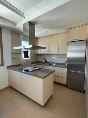 a large kitchen with a stainless steel refrigerator at A CUARTA RONDA in Melide
