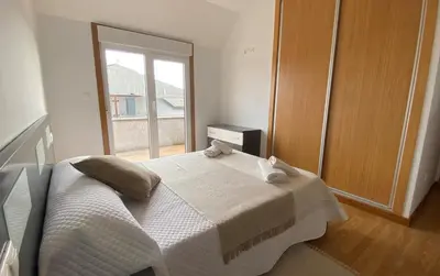 a bedroom with a bed with two towels on it at A CUARTA RONDA in Melide
