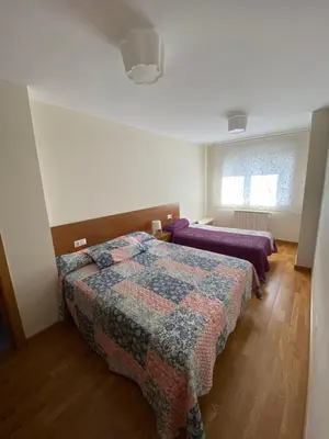 a bedroom with two beds and a window at dpCristal Calvo Sotelo 164, 4C in Sarria