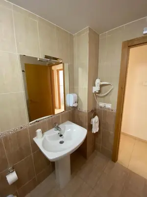 a bathroom with a white sink and a mirror at dpCristal Calvo Sotelo 164, 4C in Sarria