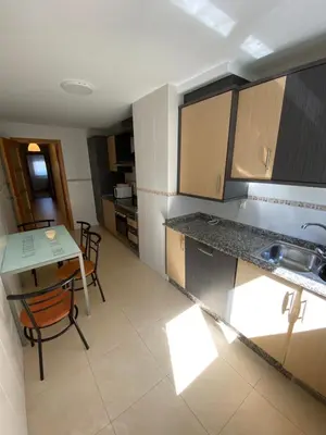 a kitchen with a table and a sink and a table at dpCristal Calvo Sotelo 164, 4C in Sarria