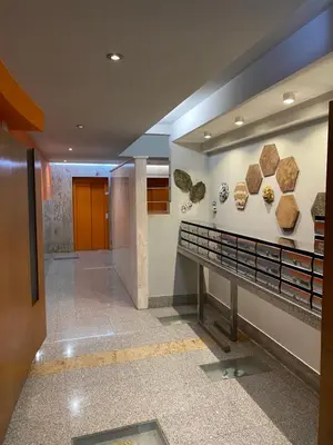 a hallway in a building with fossils on the wall at dpCristal Calvo Sotelo 164, 4C in Sarria
