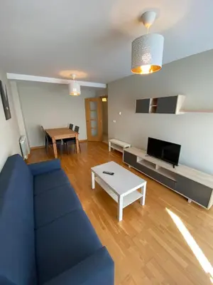 a living room with a blue couch and a table at dpCristal Calvo Sotelo 164, 4C in Sarria
