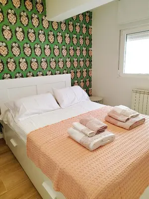 a bedroom with a bed with two towels on it at Vivienda Alameda de Santiago in Santiago de Compostela