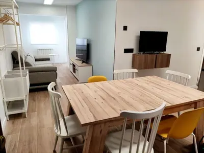 a living room with a wooden table and chairs at Vivienda Alameda de Santiago in Santiago de Compostela