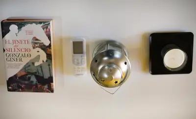 a silver ball next to a book and a speaker at dpCristal Ático Vistas al Camino in Sarria