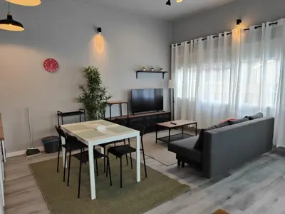 a living room with a table and a couch at Lar de Yago - Apto Barreiros A in Barreiros