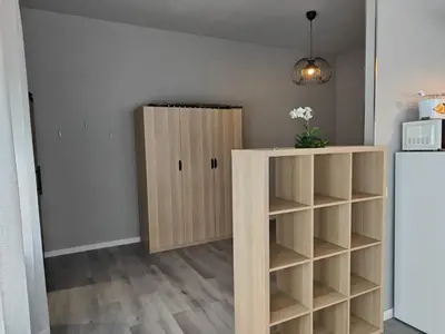 a room with a book shelf and a refrigerator at Lar de Yago - Apto Barreiros A in Barreiros