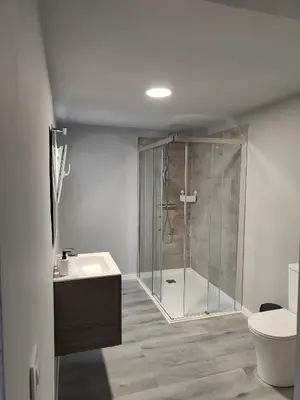 a bathroom with a shower and a toilet and a sink at Lar de Yago - Apto Barreiros A in Barreiros