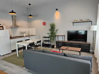 a living room with a couch and a table and a kitchen at Lar de Yago - Apto Barreiros A in Barreiros
