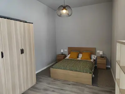 a bedroom with a bed with yellow pillows at Lar de Yago - Apto Barreiros A in Barreiros