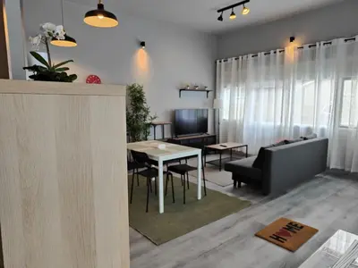 a living room with a table and a couch at Lar de Yago - Apto Barreiros A in Barreiros