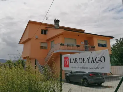 a house with a sign in front of it at Lar de Yago - Casa in Barreiros
