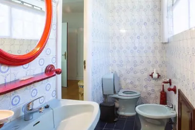 a bathroom with a sink and a toilet and a mirror at Playa Miño Sombreu in Miño