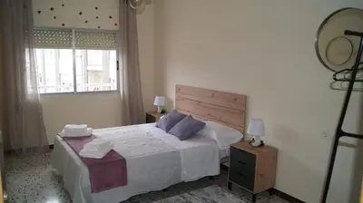 a bedroom with a large bed and a window at Dona Branca in Quiroga