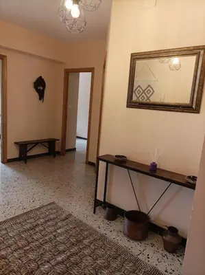 a living room with a table and a mirror on the wall at Dona Branca in Quiroga