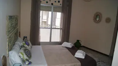 a bedroom with a bed with towels on it at Dona Branca in Quiroga